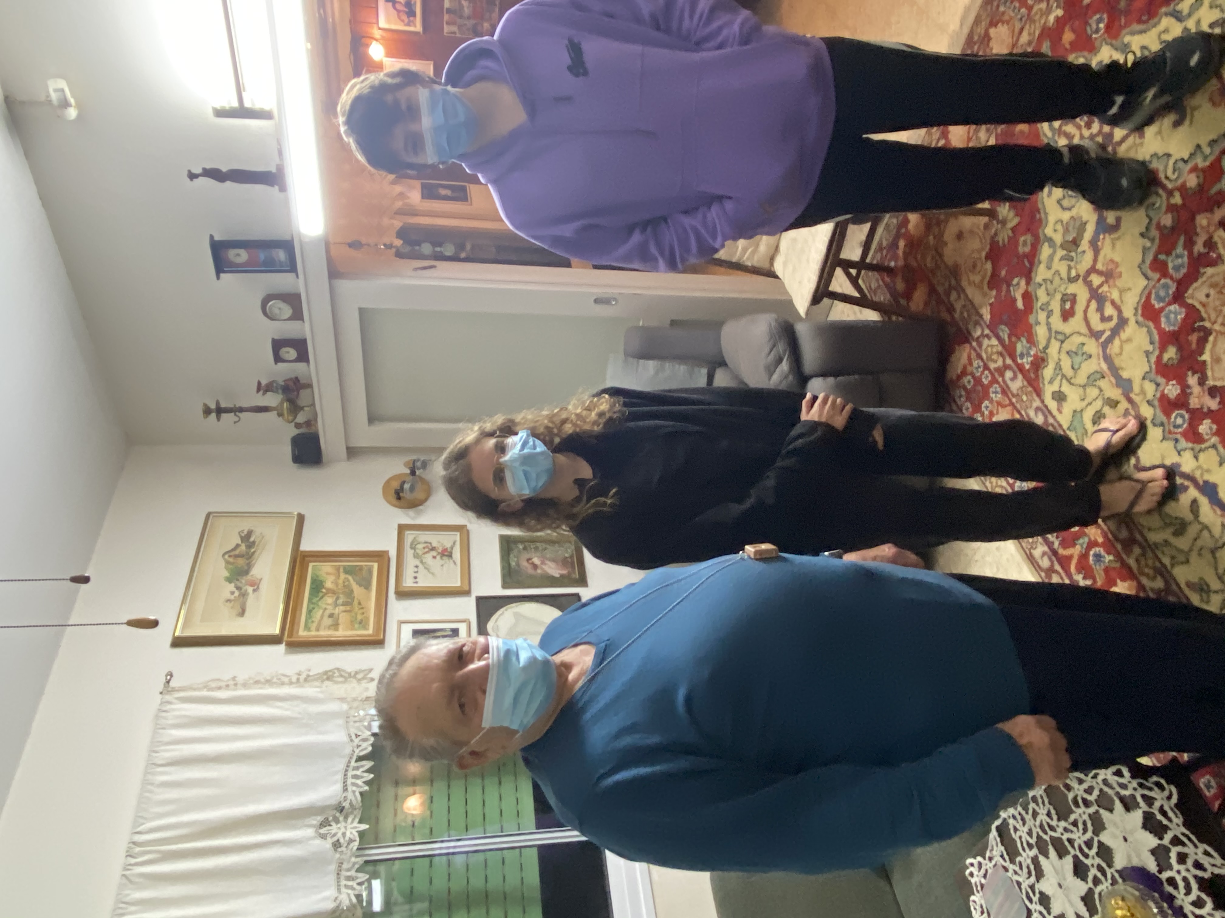 Asher with the young volunteers Daniel and Hila at his home in Shavei Zion.