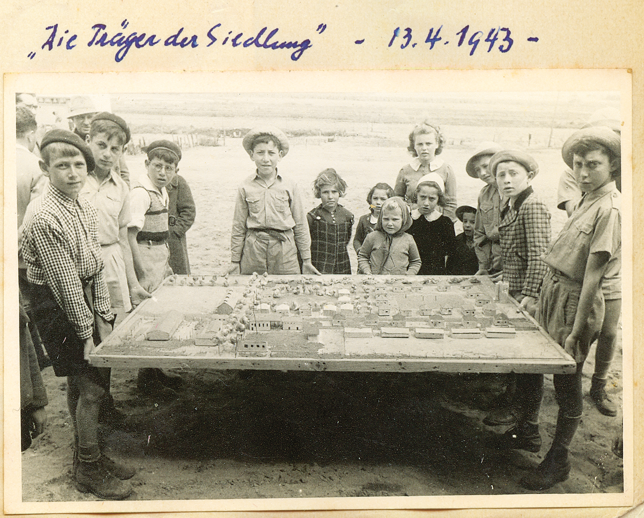 Hillel and his classmates with a model of Shavei Tzion, 1943.