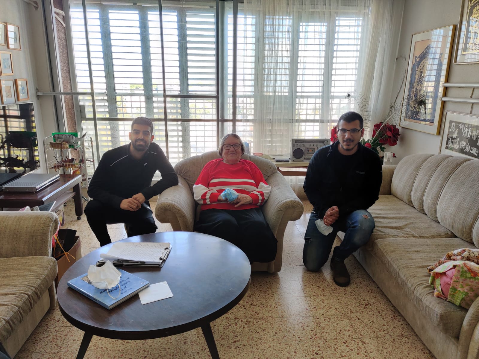 Shoshana at her home in Haifa with the project interviewers, Or (at left) and Sharif.